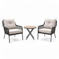Woven rattan outdoor seating set with cushioned chairs and round table